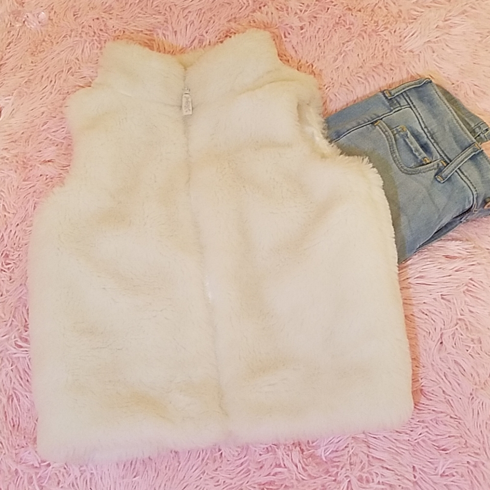 Fluffy zip up white vest.